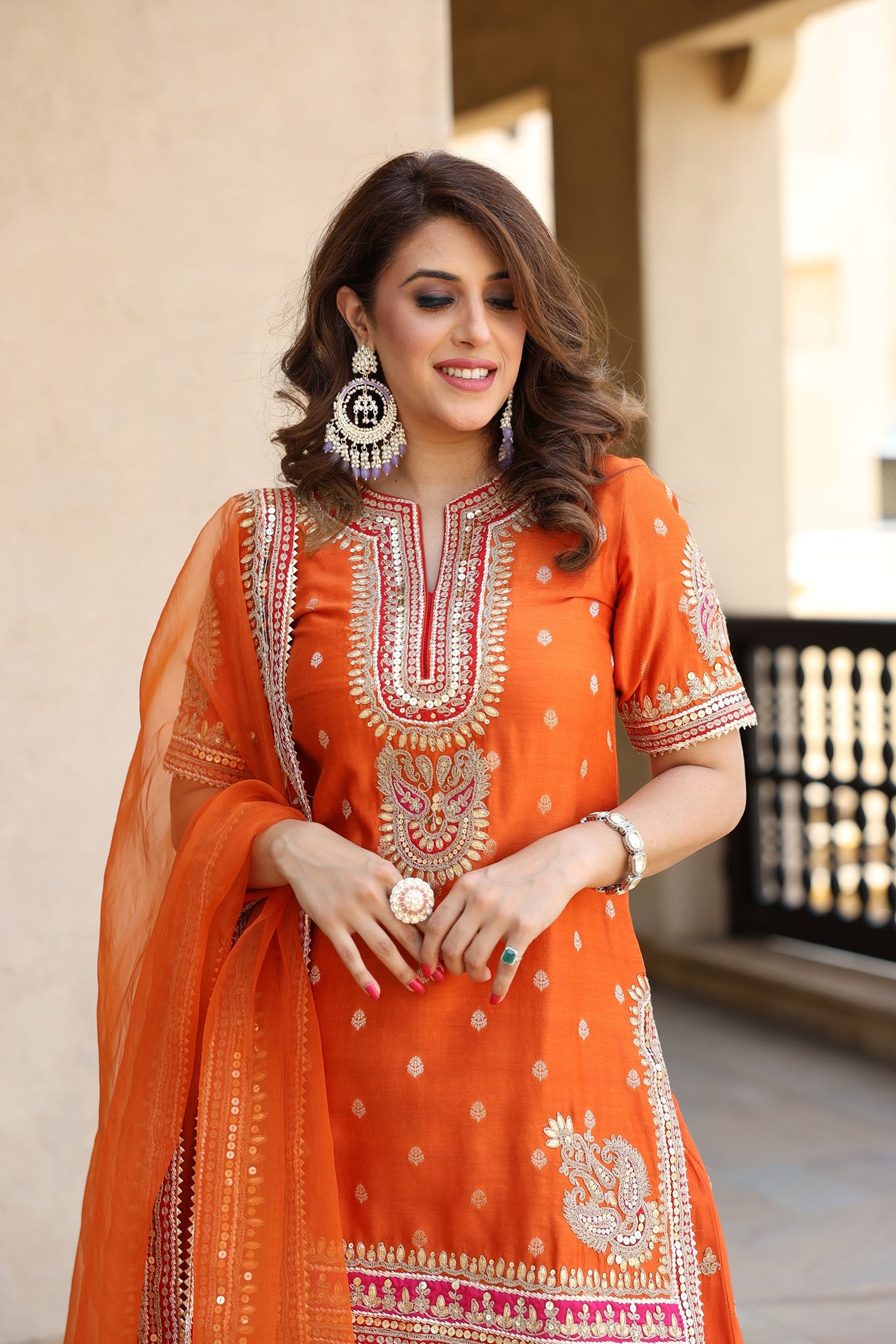 ANJALI KHUSHALANI IN AREESHA - BURNT ORANGE SHORT KURTA WITH SHARARA AND DUPATTA