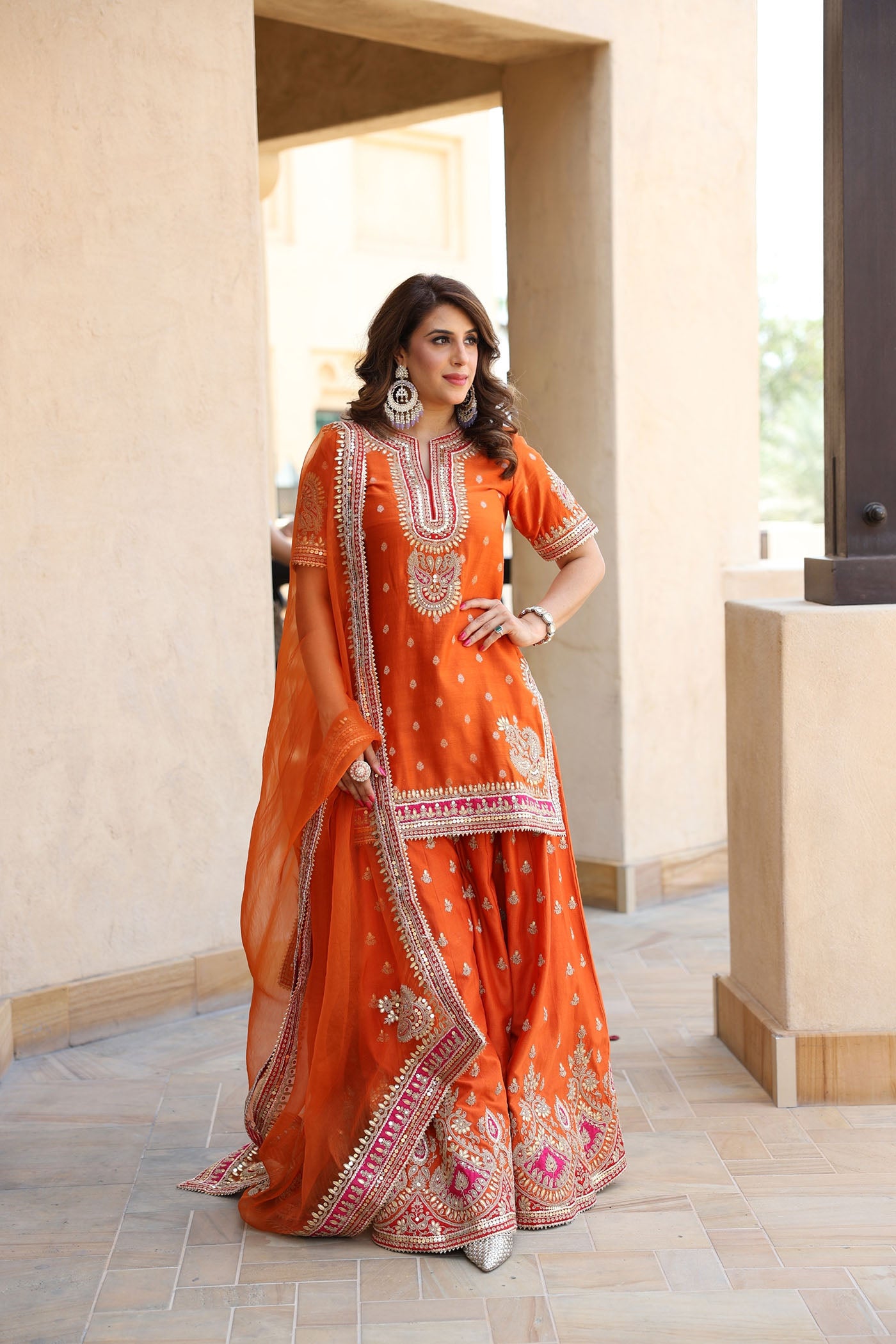 ANJALI KHUSHALANI IN AREESHA - BURNT ORANGE SHORT KURTA WITH SHARARA AND DUPATTA