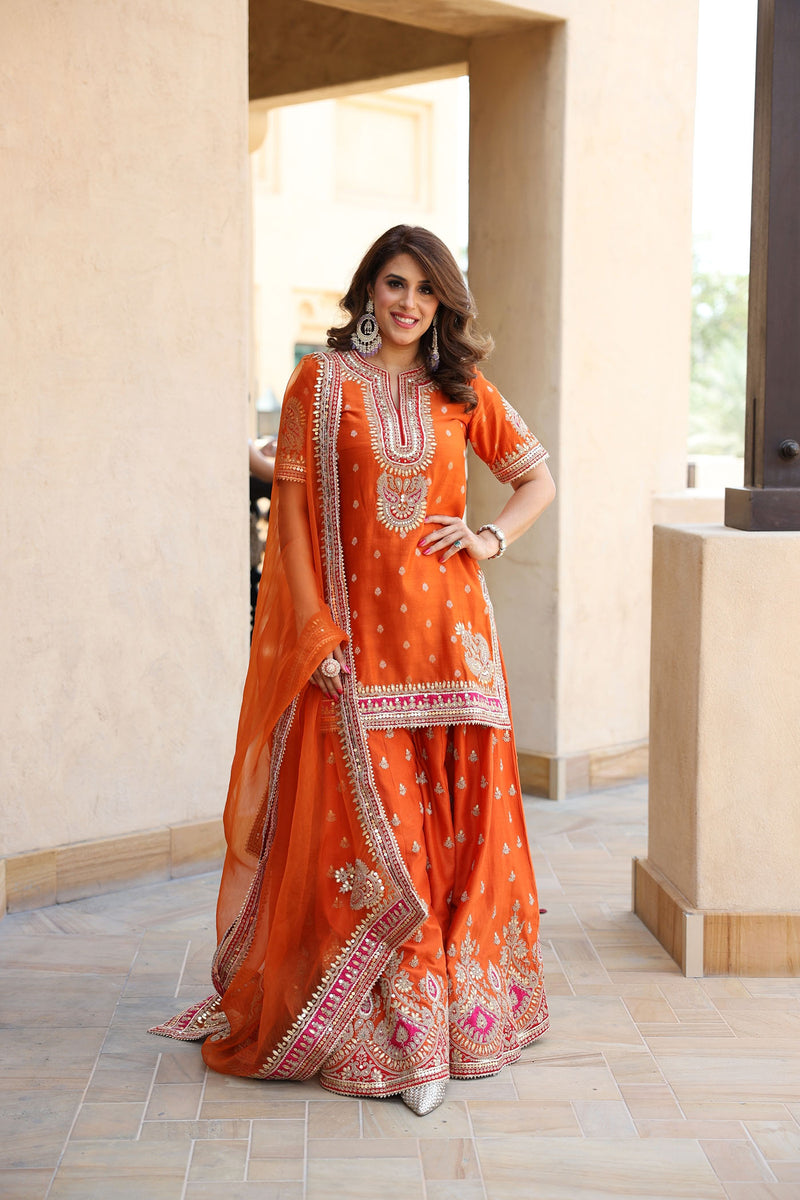 ANJALI KHUSHALANI IN AREESHA - BURNT ORANGE SHORT KURTA WITH SHARARA AND DUPATTA